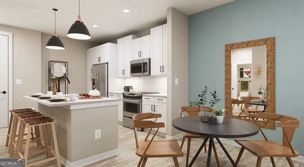 a kitchen with stainless steel appliances kitchen island a table and chairs in it
