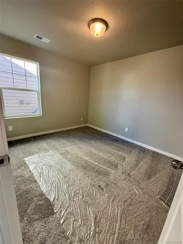 an empty room with a fireplace