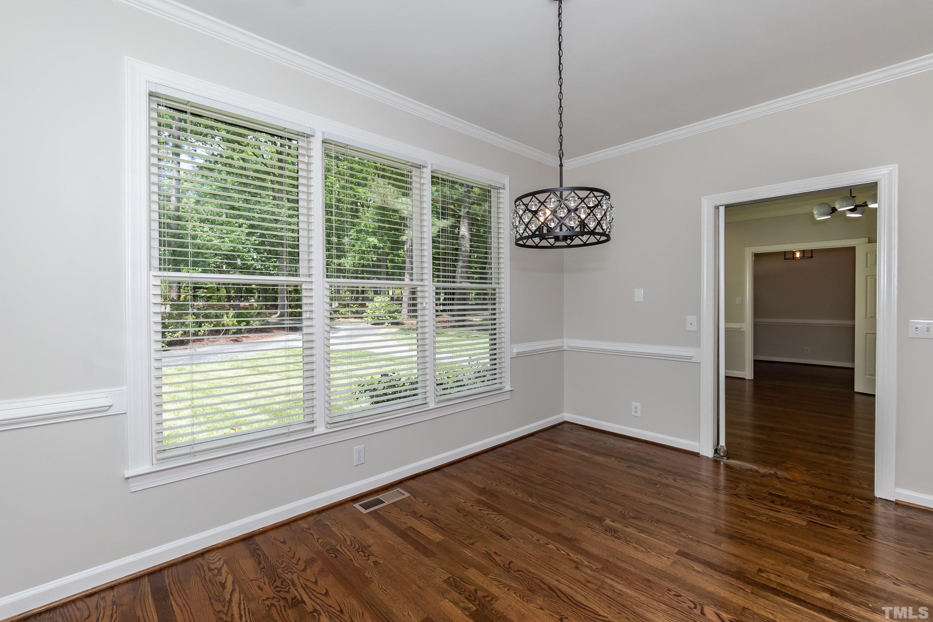 2215 Umstead Road Durham, NC 27712 - Photo 19 of 63 a view of an empty room with wooden floor and a window