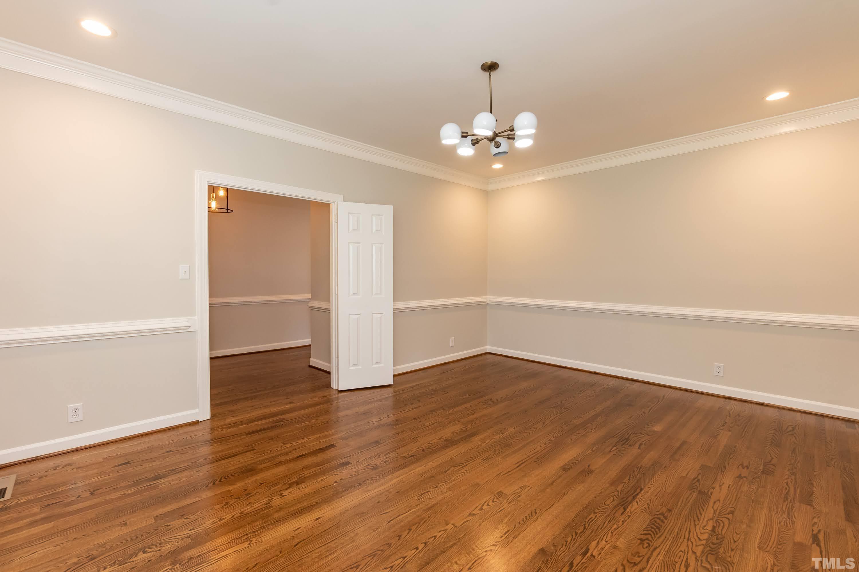 2215 Umstead Road Durham, NC 27712 - Photo 20 of 63 an empty room with wooden floor and ceiling fan