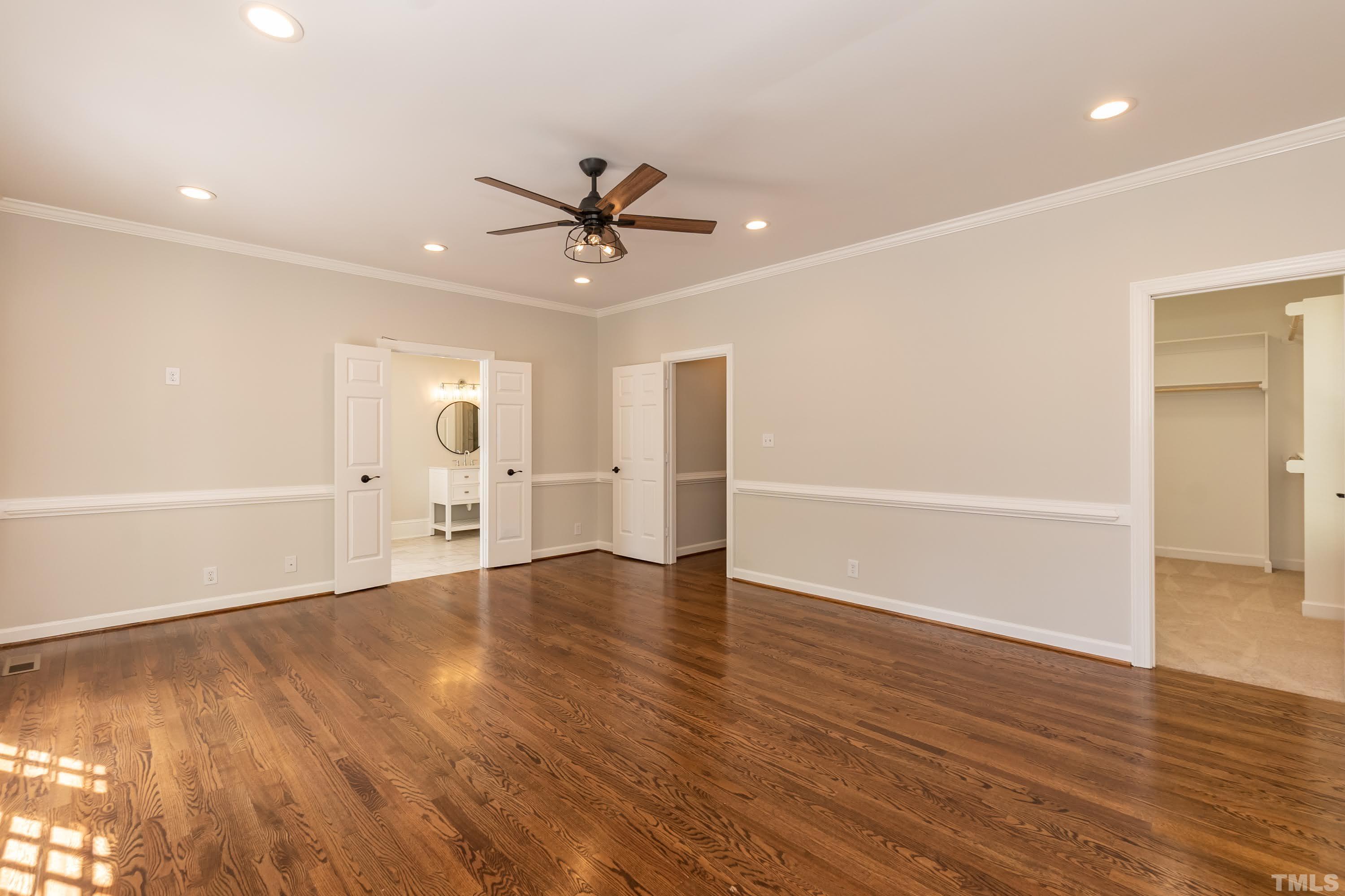 2215 Umstead Road Durham, NC 27712 - Photo 25 of 63 a view of an empty room with wooden floor and a ceiling fan
