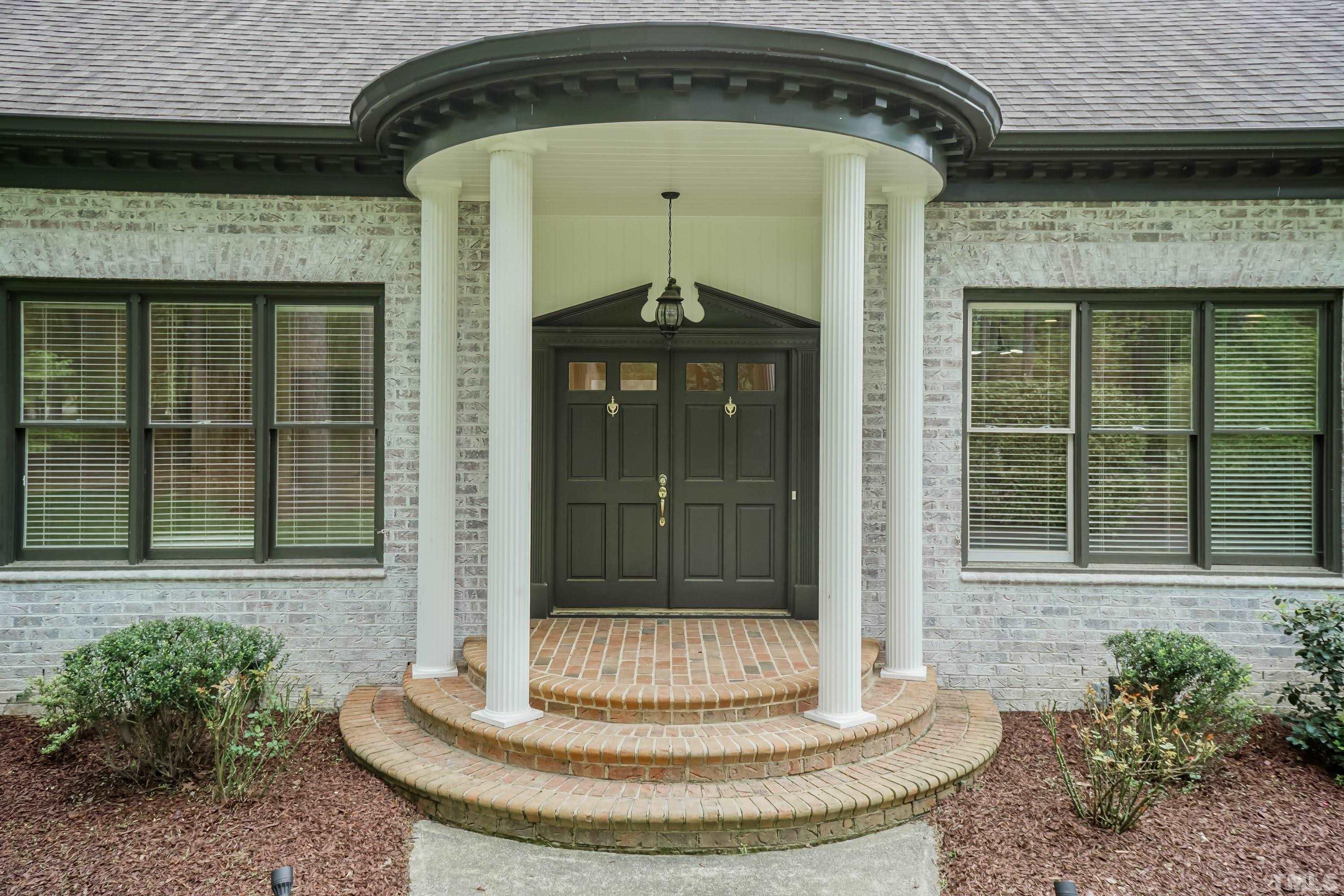 2215 Umstead Road Durham, NC 27712 - Photo 3 of 63 a front view of a house with a porch