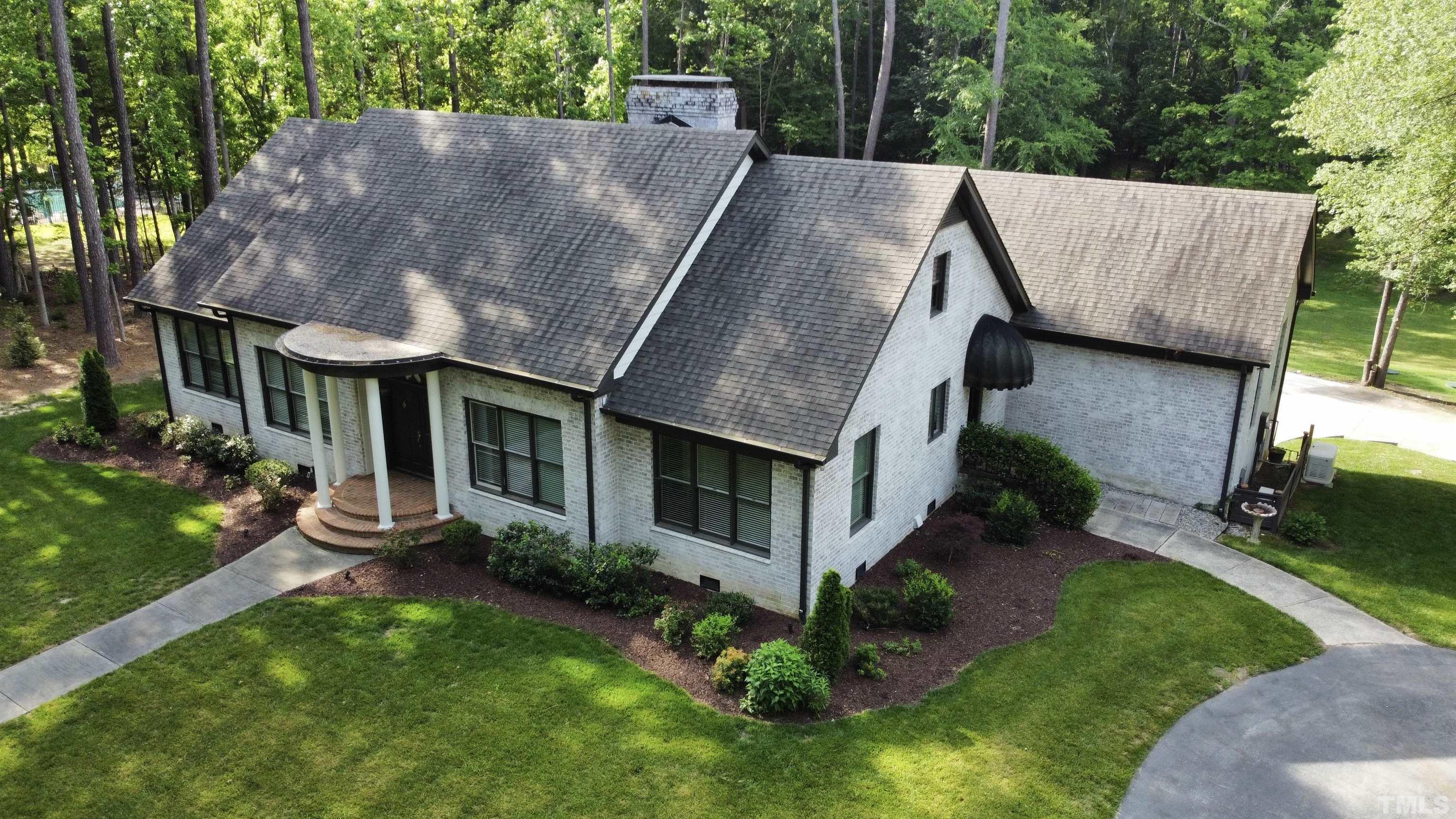 2215 Umstead Road Durham, NC 27712 - Photo 60 of 63 a aerial view of a house next to a big yard and large trees