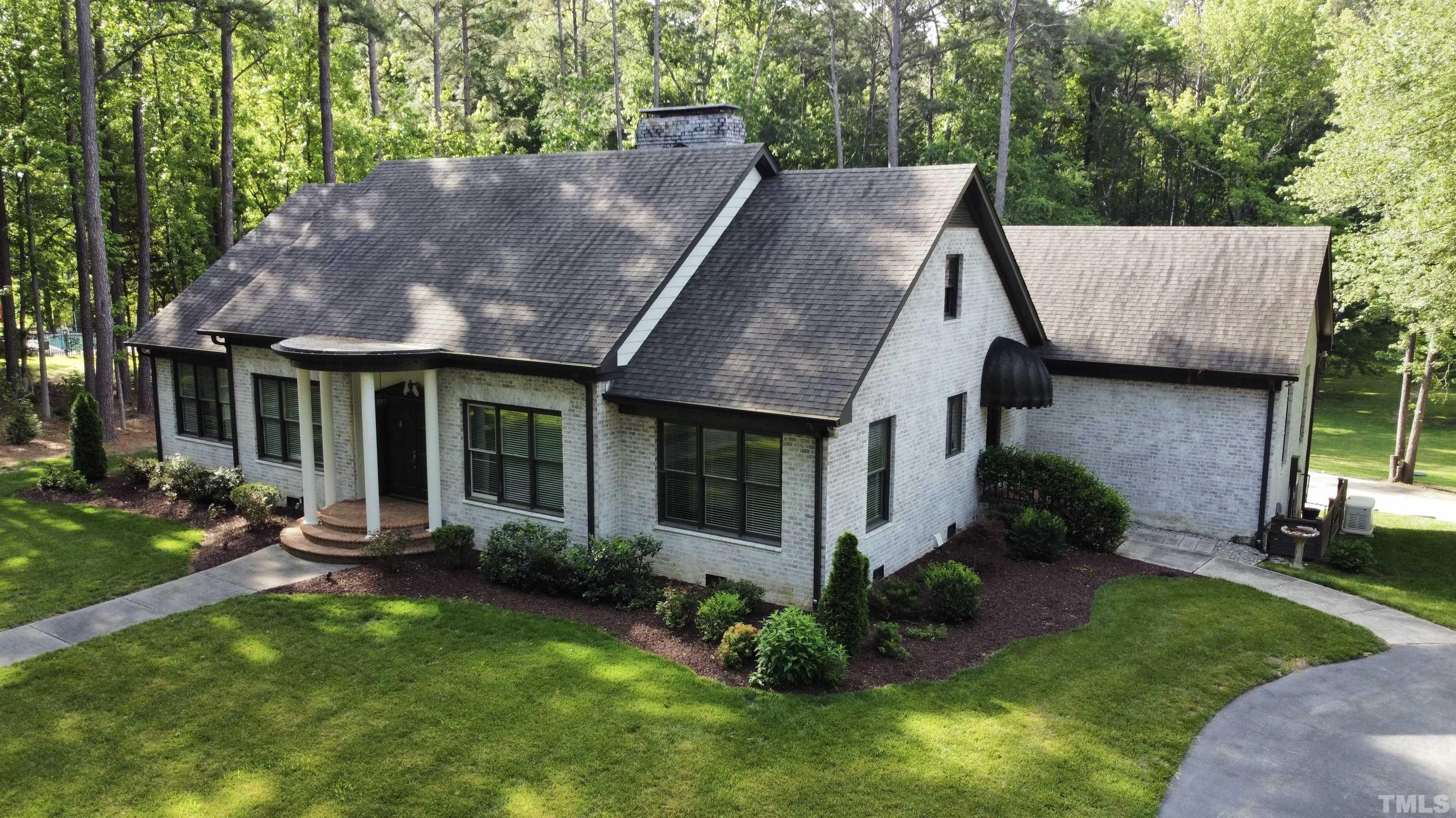 2215 Umstead Road Durham, NC 27712 - Photo 61 of 63 a view of a house with a yard plants and large tree