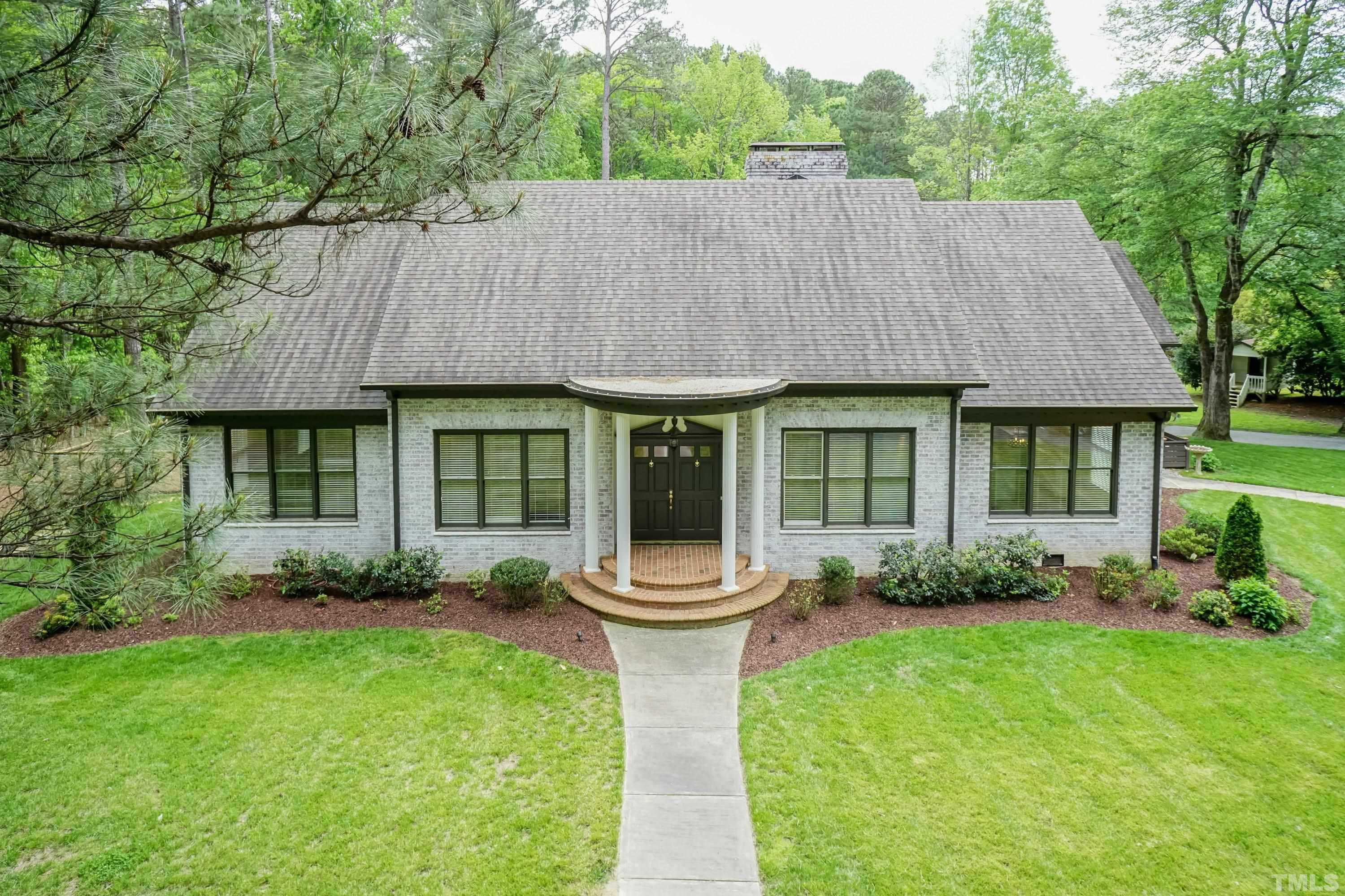 2215 Umstead Road Durham, NC 27712 - Photo 63 of 63 a front view of a house with a garden and plants