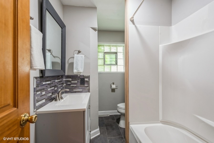 1S866 Green Road Elburn, IL 60119 - Photo 22 of 55 a bathroom with a sink toilet and shower