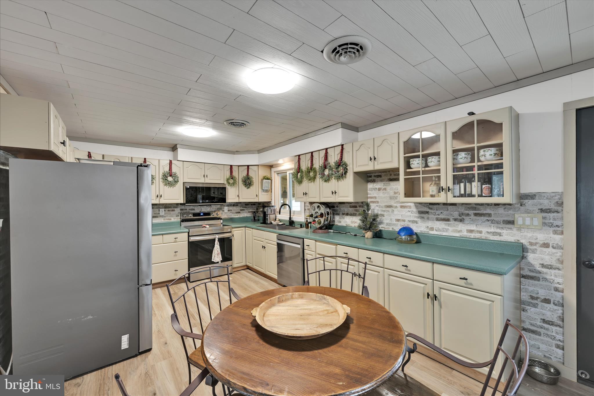 40 Long Stretch Road Pine Grove, PA 17963 - Photo 11 of 37 a kitchen with stainless steel appliances granite countertop a sink a stove a refrigerator cabinets and chairs