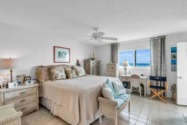 a spacious bedroom with a bed a table and chair