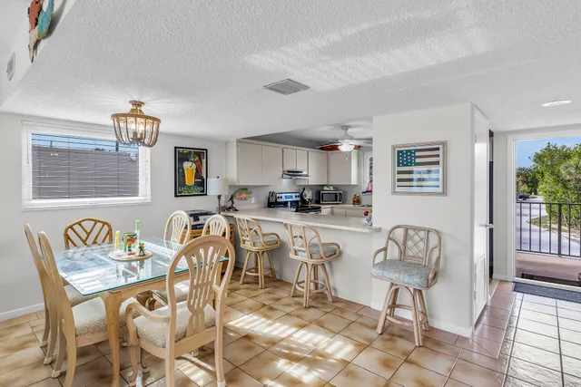 a living room with furniture and a kitchen view
