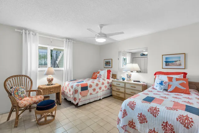 a bedroom with two beds and a chandelier