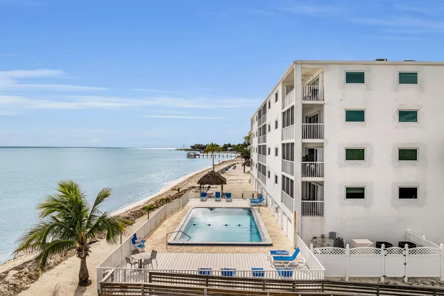 a view of a balcony with potted plants and palm trees