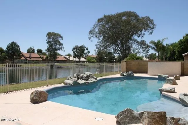 a view of a lake with a house in the background