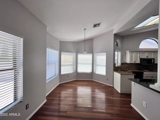 a kitchen with stainless steel appliances granite countertop a stove and a wooden floors