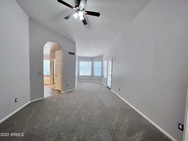 a view of empty room with ceiling fan