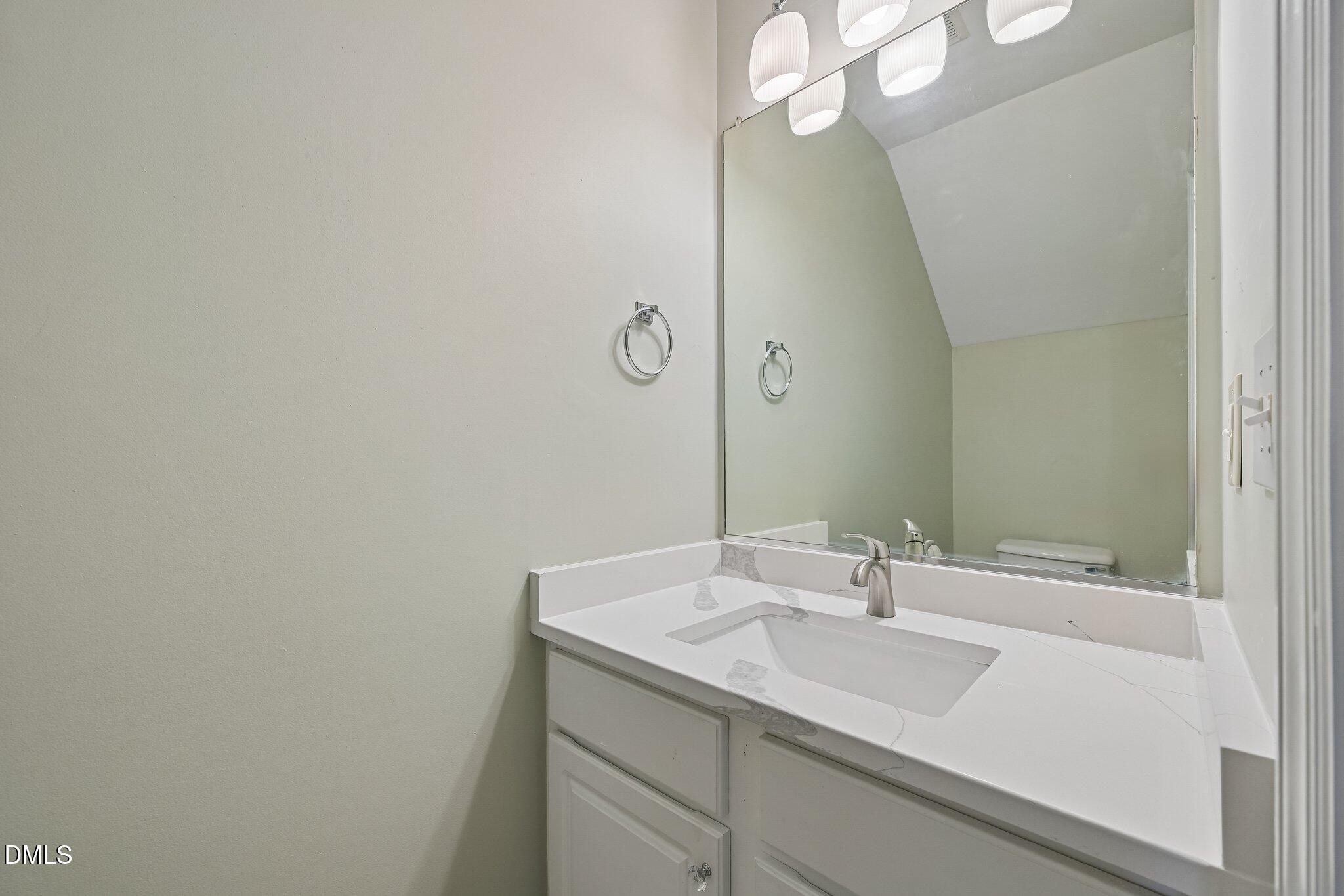 278 South Raleigh Street Angier, NC 27501 - Photo 27 of 35 a bathroom with a sink and a mirror
