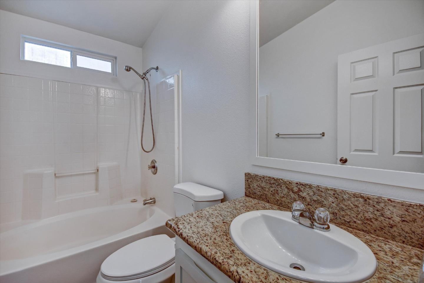 60 Wilson Way, Unit 117 Milpitas, CA 95035 - Photo 12 of 29 a bathroom with a granite countertop sink toilet and shower