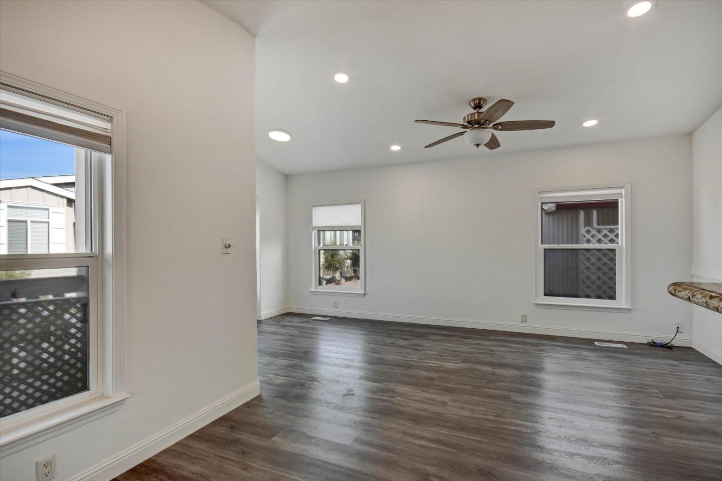 60 Wilson Way, Unit 117 Milpitas, CA 95035 - Photo 22 of 29 a view of room with hardwood floor and a ceiling fan