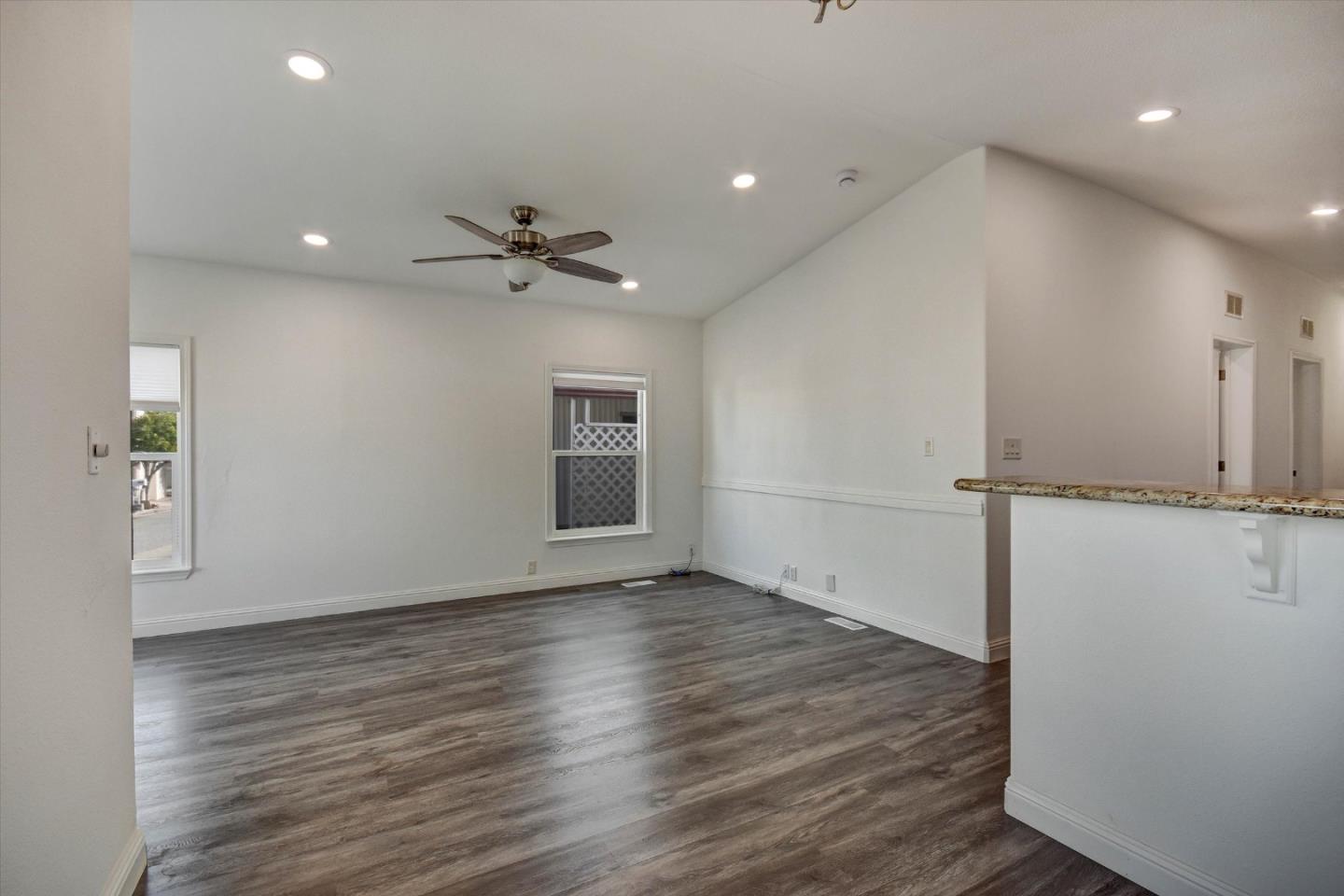 60 Wilson Way, Unit 117 Milpitas, CA 95035 - Photo 23 of 29 an empty room with wooden floor and a ceiling fan
