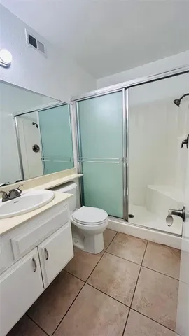 a bathroom with a toilet sink and shower