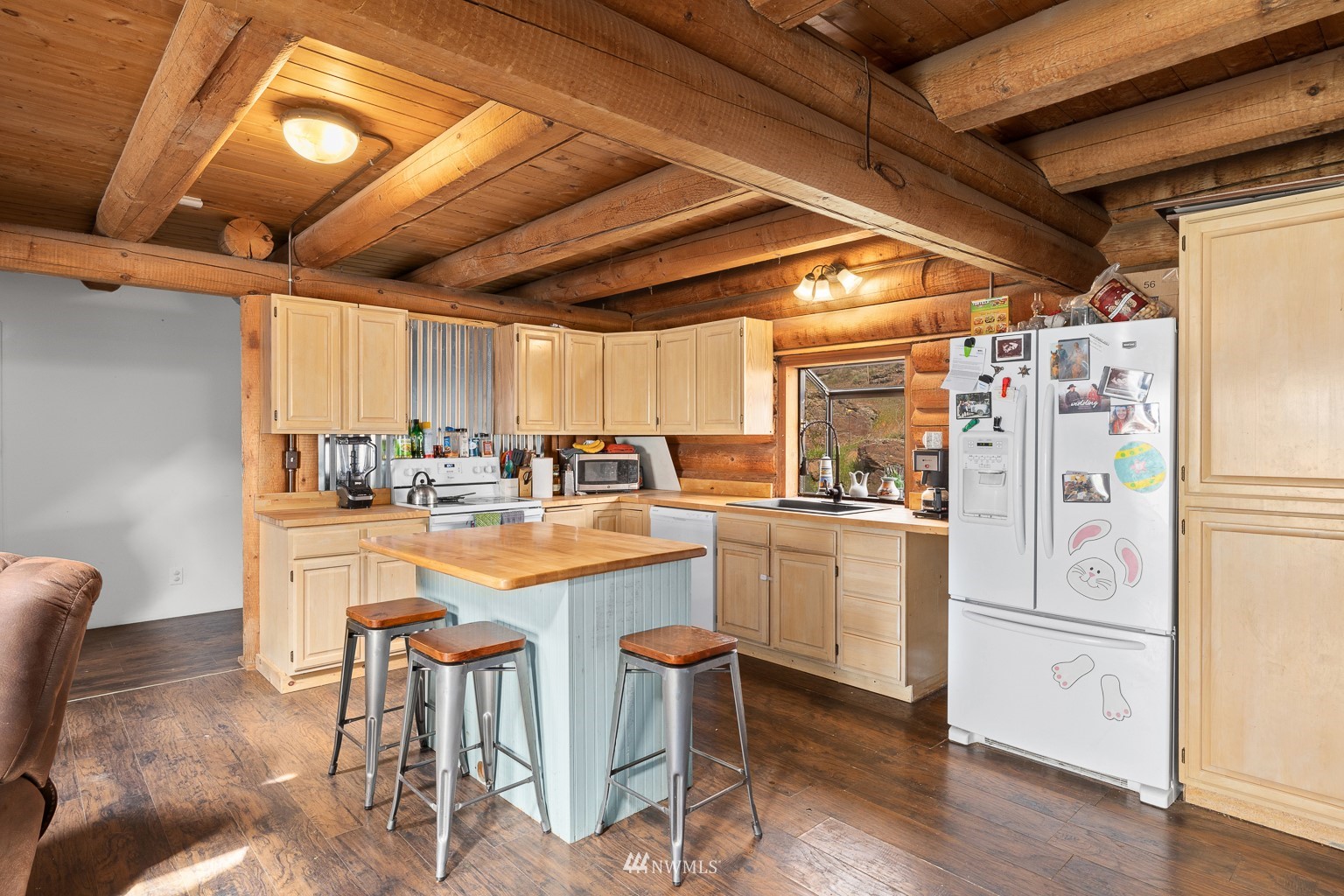 4301 Martin Road Northwest Ephrata, WA 98823 - Photo 12 of 40 a kitchen with refrigerator and white cabinets