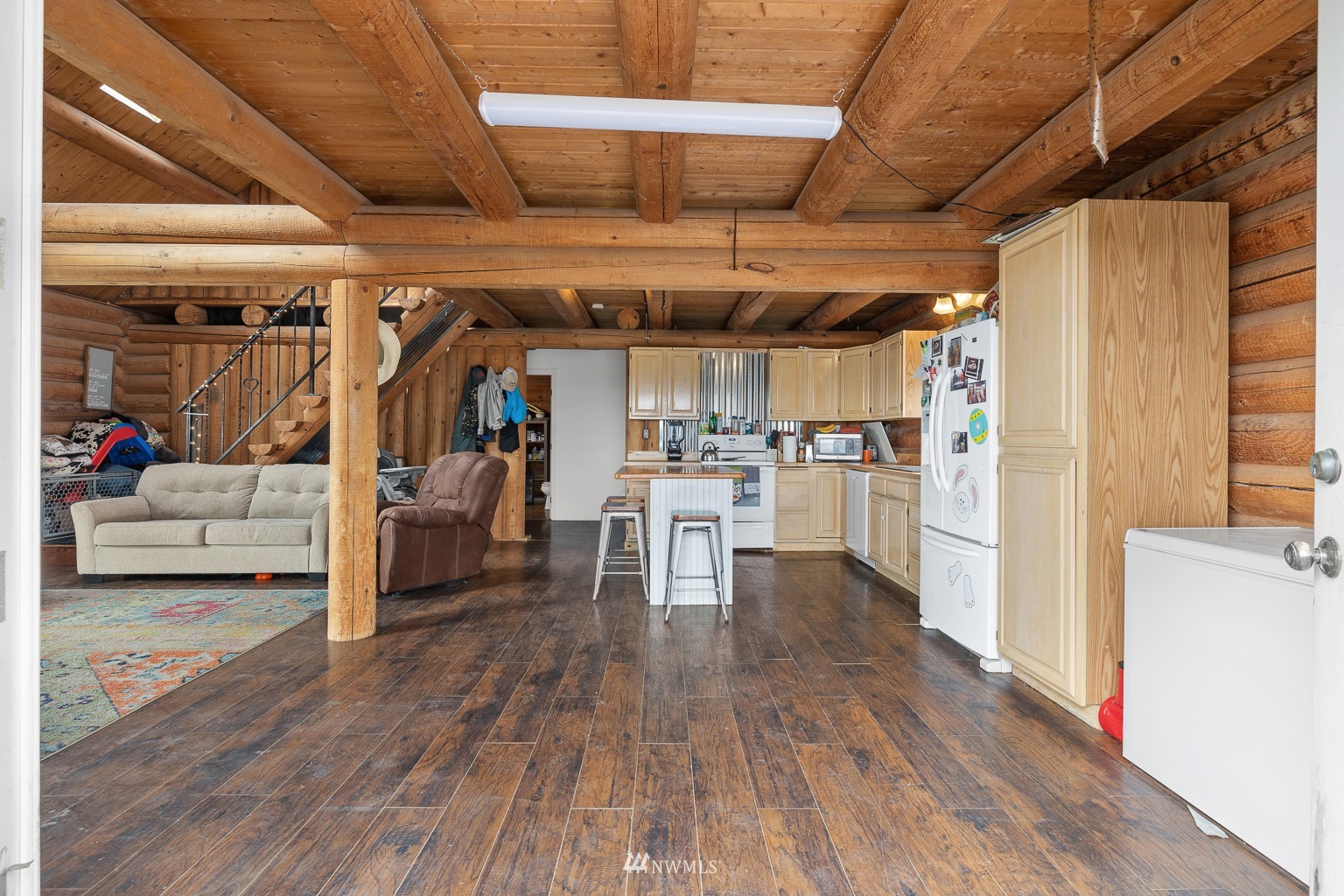 4301 Martin Road Northwest Ephrata, WA 98823 - Photo 16 of 40 a view of a livingroom with wooden floor and a ceiling fan