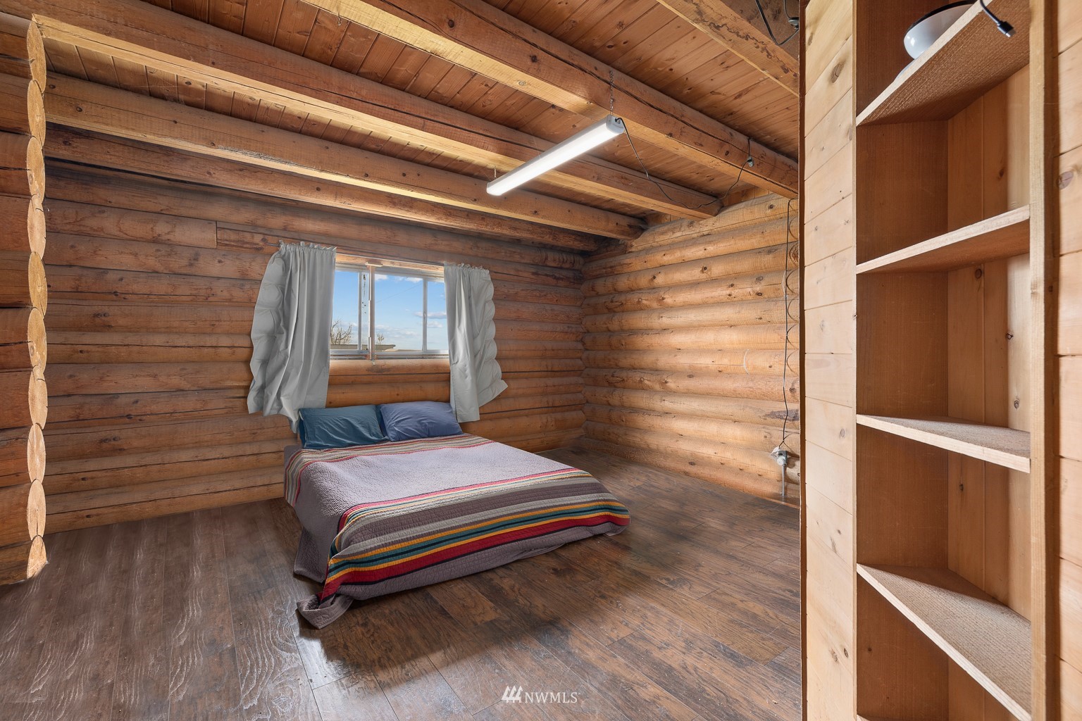 4301 Martin Road Northwest Ephrata, WA 98823 - Photo 22 of 40 a bedroom with a bed and wooden floor