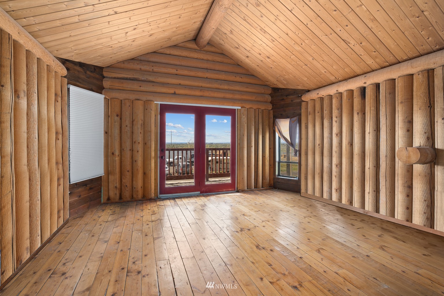 4301 Martin Road Northwest Ephrata, WA 98823 - Photo 27 of 40 an empty room with wooden floor and windows