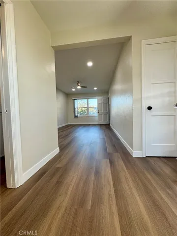 a view of wooden floor and windows in an empty room