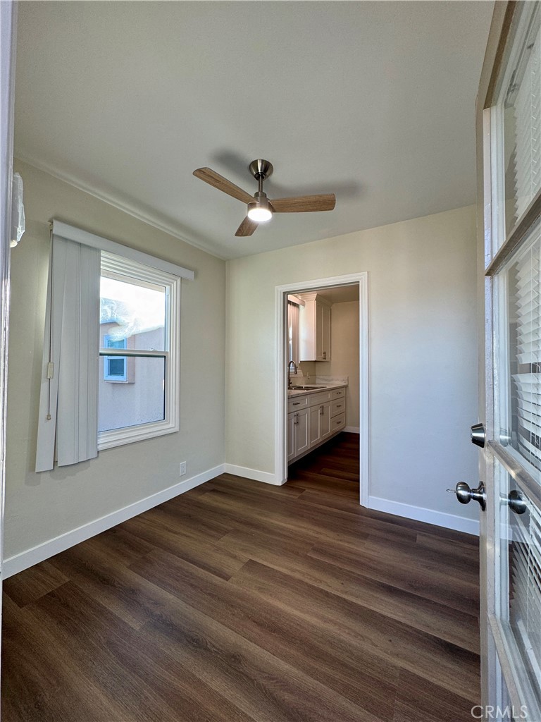3402-3404 Gaviota Avenue, Unit B Long Beach, CA 90807 - Photo 4 of 20 a view of an empty room with a window and wooden floor