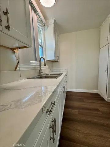 a kitchen with a sink and a mirror