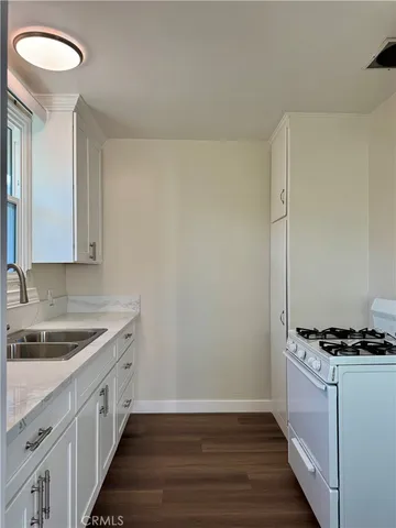 a kitchen with sink and cabinets