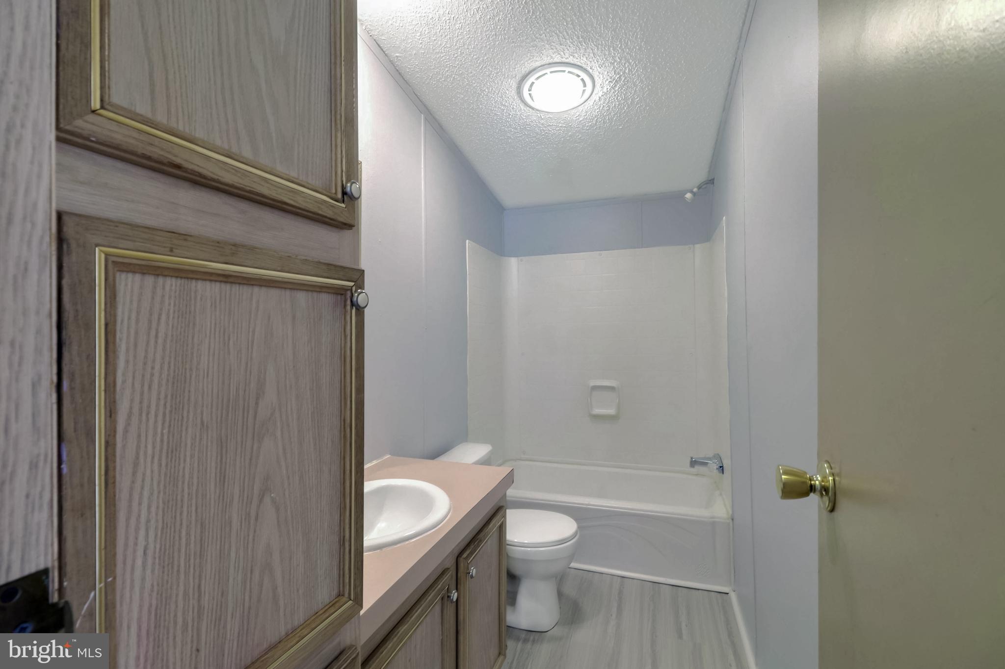 7810 Clark Road, Unit E15 Hanover, MD 21076 - Photo 14 of 20 a bathroom with a sink a toilet and shower