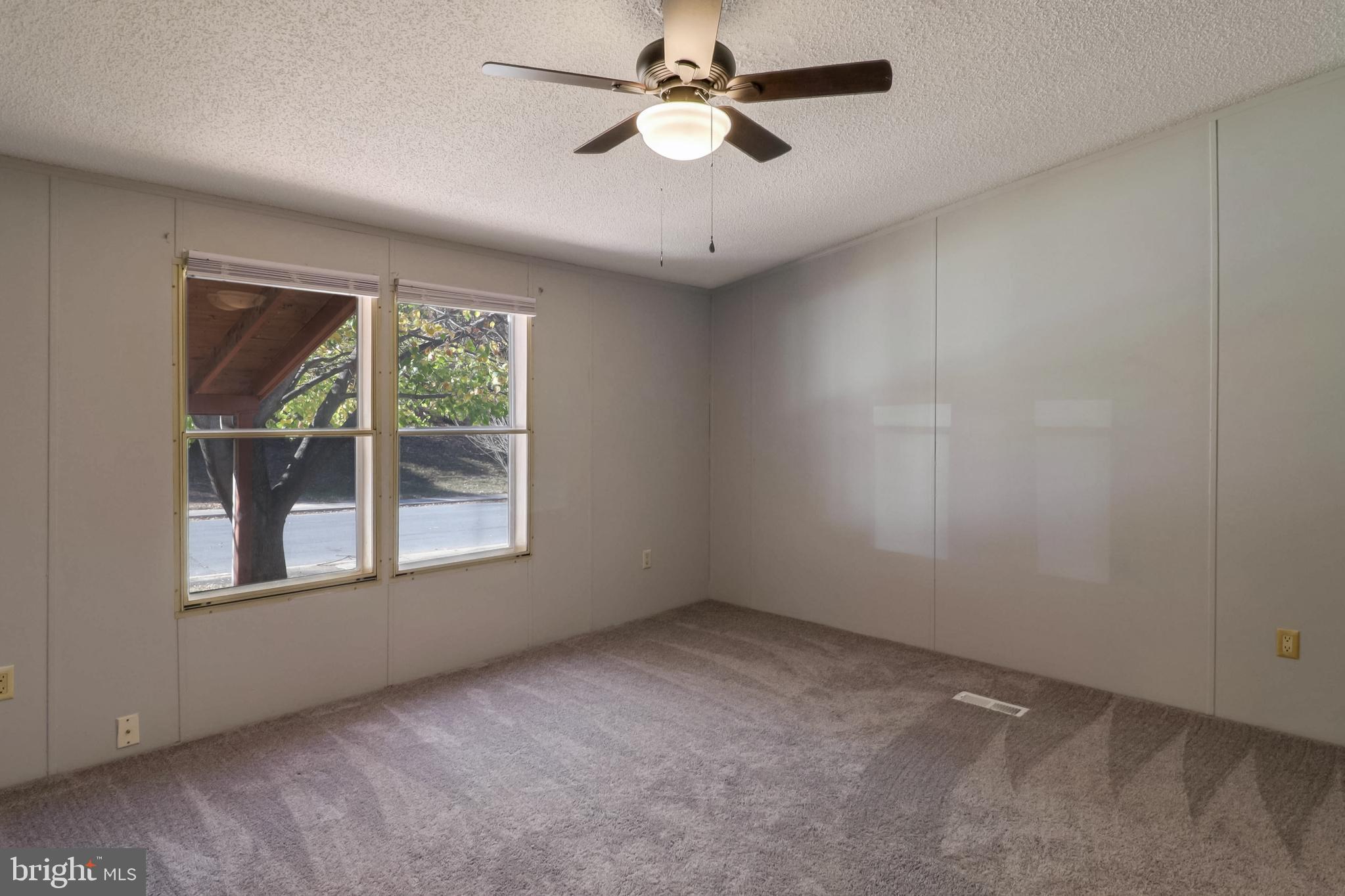 7810 Clark Road, Unit E15 Hanover, MD 21076 - Photo 16 of 20 an empty room with a window and a fan