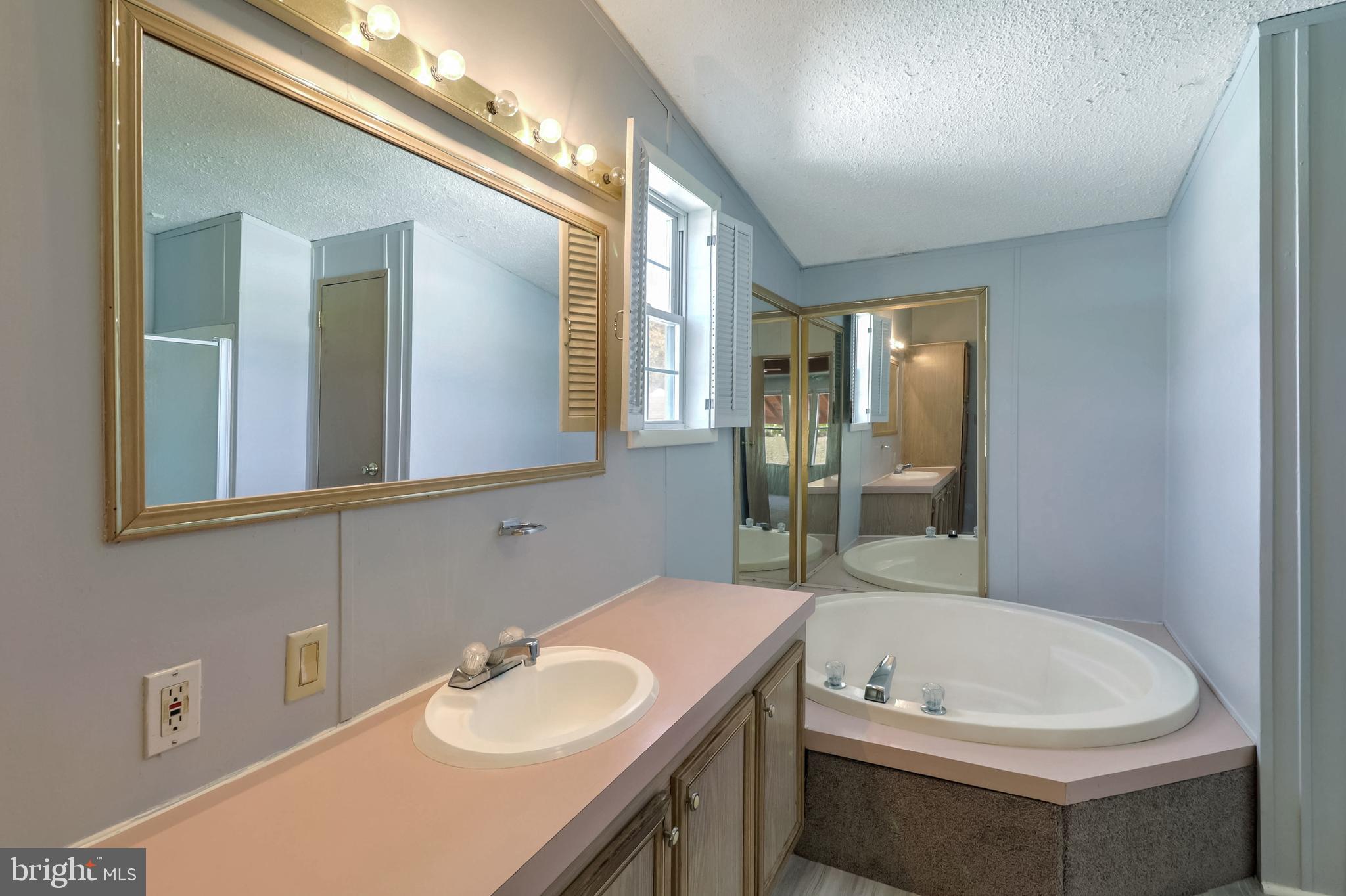 7810 Clark Road, Unit E15 Hanover, MD 21076 - Photo 18 of 20 a bathroom with a sink and a mirror