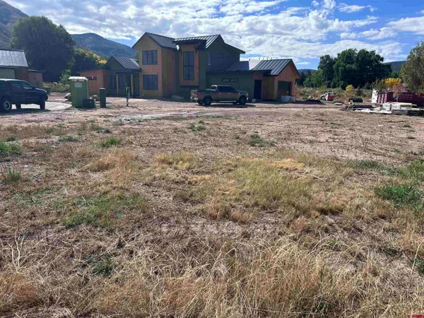 a view of a barn in the middle of a yard