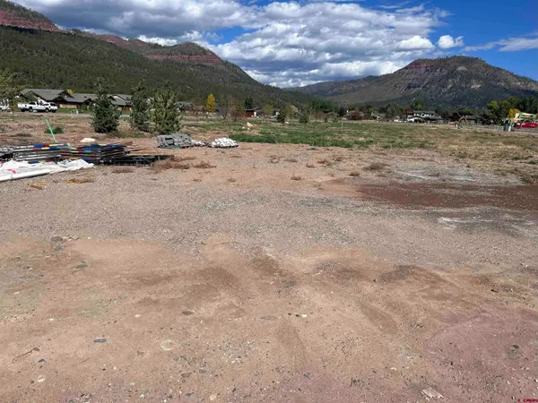 a view of a dirt road with mountain view