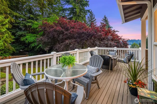 a view of a house with a deck and furniture