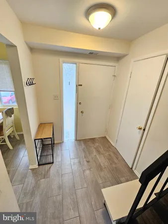 a view of kitchen with furniture and a refrigerator