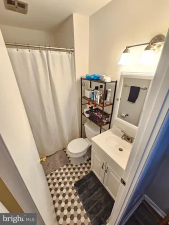 a bathroom with a sink toilet and mirror