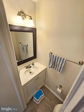 a bathroom with a toilet and a mirror