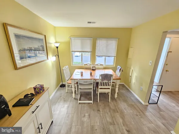a view of a dining room with furniture and a rug