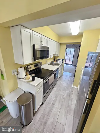 a white refrigerator freezer sitting inside of a kitchen