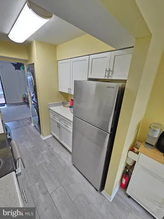 a kitchen with a stove a sink and a refrigerator