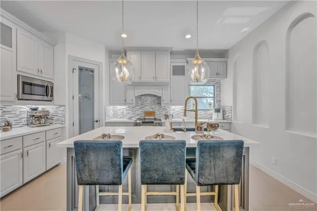 a kitchen with granite countertop cabinets a dining table and chairs