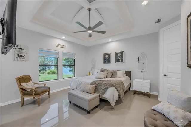 a spacious bedroom with a bed a couch and a window