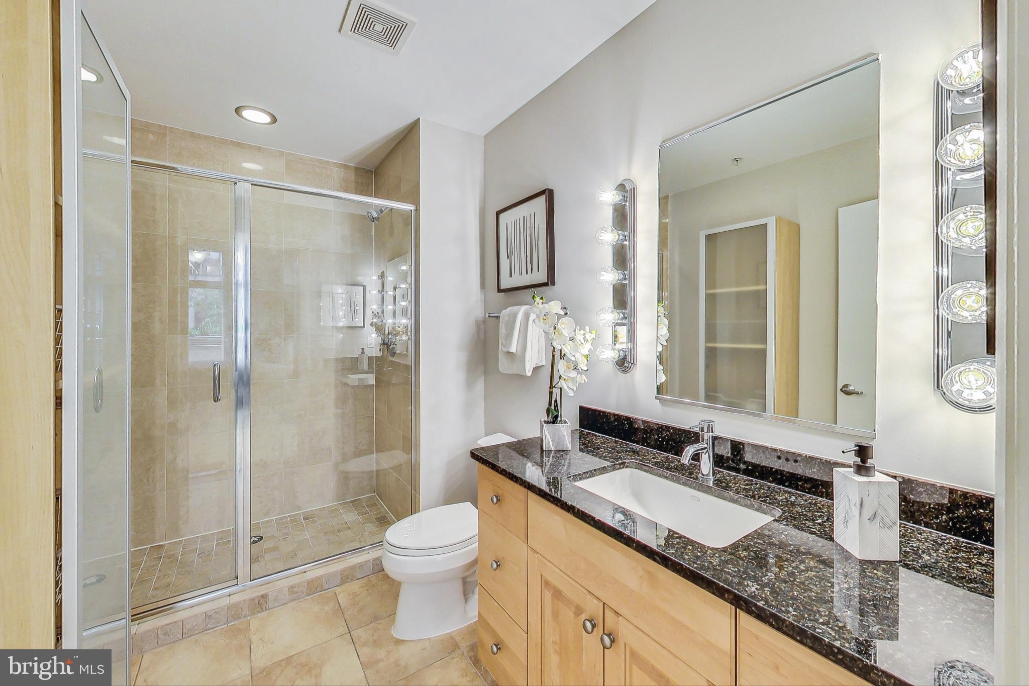 811 4th Street Northwest, Unit 112 Washington, DC 20001 - Photo 12 of 44 a bathroom with a granite countertop sink toilet and shower