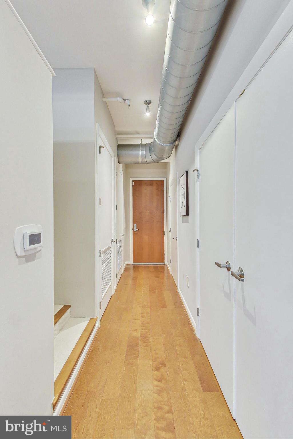 811 4th Street Northwest, Unit 112 Washington, DC 20001 - Photo 13 of 44 a view of a hallway with wooden floor and closet