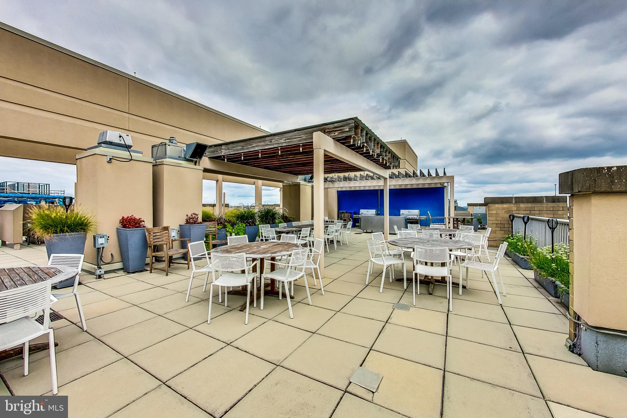 811 4th Street Northwest, Unit 112 Washington, DC 20001 - Photo 23 of 44 a view of a patio with dining table and chairs with a barbeque grill and a fireplace