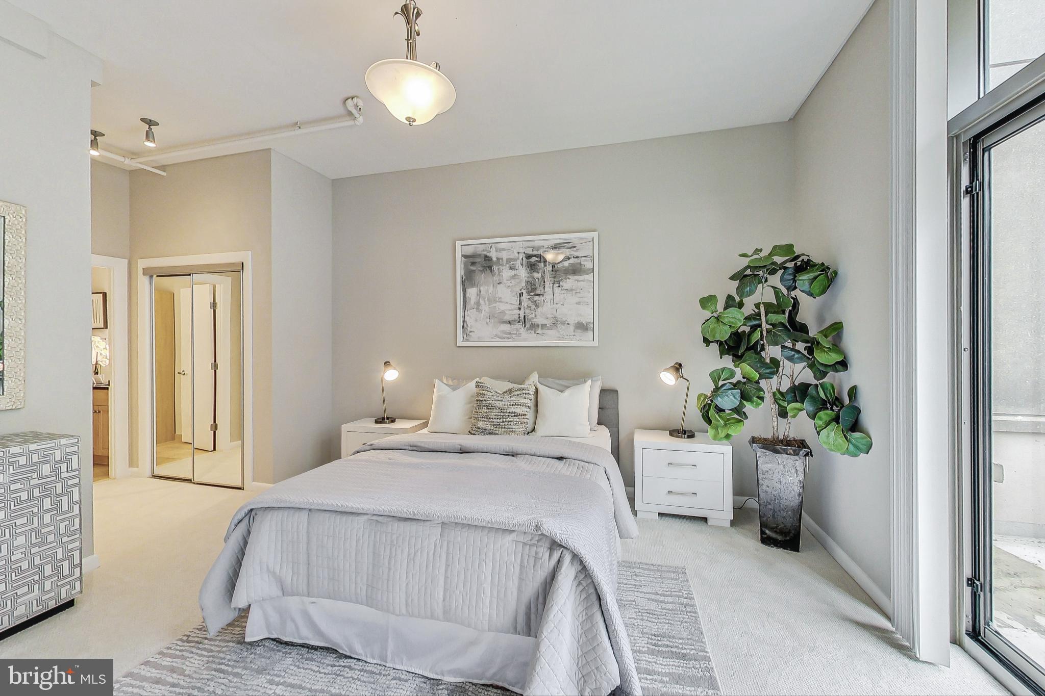 811 4th Street Northwest, Unit 112 Washington, DC 20001 - Photo 8 of 44 a bedroom with bed and a chandelier