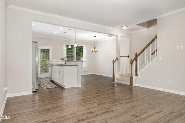 a view of a kitchen with wooden floor and a sink